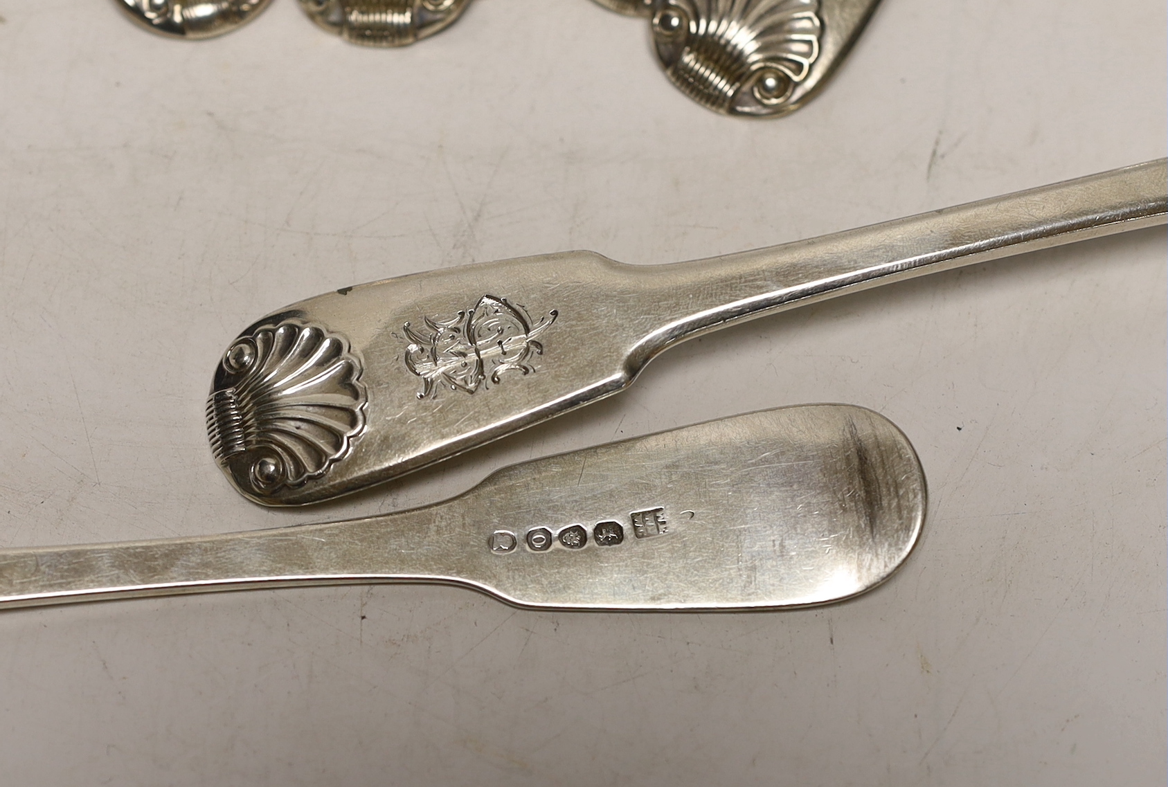 A harlequin set of seven early 19th century silver fiddle and shell pattern table spoons, various date and makers, 18.7oz.